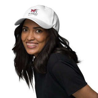 White adjustable dad hat with K-AROLE logo worn by a smiling woman with long dark hair