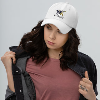 White K-AROLE branded dad hat worn by a young woman with dark wavy hair against a plain background