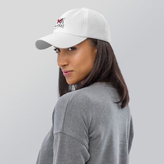 White K-AROLE dad hat with a logo worn by a woman with long dark hair in a gray top