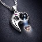 Close-up of heart projection necklace showing photo projection detail, realistic macro jewelry photography