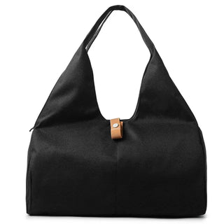 Large black women's duffel bag with leather accent. Versatile sports and travel accessory with multiple storage compartments and pockets. Lightweight yet durable fabric, ideal for fitness, swimming, and weekend getaways.