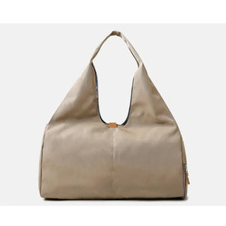 Stylish beige women's duffle bag with a casual, modern design. The bag features a spacious interior, a strap handle, and a zipper closure, making it ideal for sports, fitness, or weekend travel. This versatile accessory from the K-AROLE brand can elevate any athleisure or casual outfit.