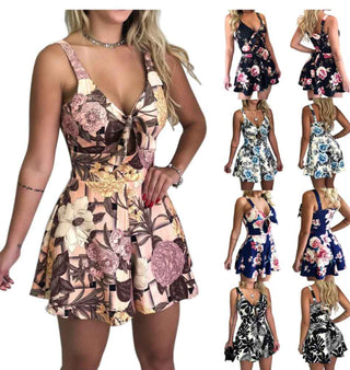 Elegant floral printed sleeveless mini dress showcasing a plunging neckline and a fitted waistline. The dress features an eye-catching vibrant floral pattern creating a stylish and feminine look.