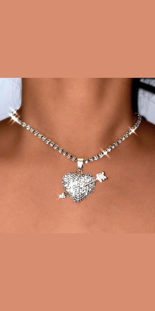 Stunning rhinestone-encrusted heart pendant necklace from K-AROLE, a trendy women's fashion store. The elegant silver chain and sparkling crystal details elevate any casual or formal look.