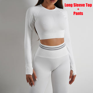 Long-sleeved white crop top and matching fitted pants, showcasing a stylish athletic yet chic ensemble.