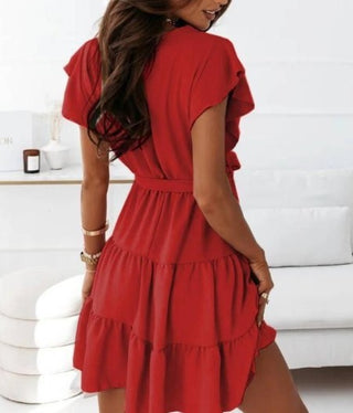 Stylish red V-neck dress with tiered skirt and waist tie, ideal for summer fashion.