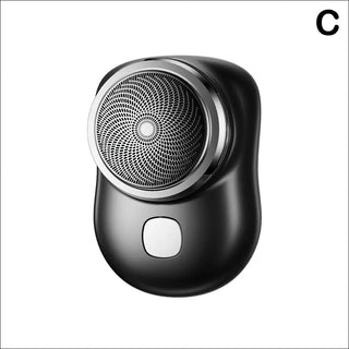 Sleek black electric mini shaver with a textured circular design, suitable for short beards and facial grooming on the go.