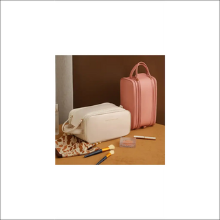 Stylish pink cosmetic bag with multi-compartment design, perfect for organizing and carrying beauty essentials on the go.