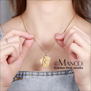 Elegant gold-toned stainless steel envelope-shaped pendant necklace from K-AROLE, a women's fashion and accessories brand, showcasing their quality jewelry offering.