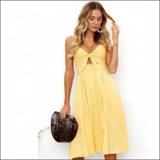 Chic summer dress with plunging neckline and cinched waist, clutch purse, and model's beautiful wavy blonde hair.