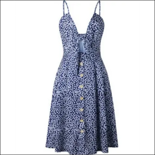 Sleeveless blue and white floral summer dress with backless design and button-down front, displayed on a plain background.