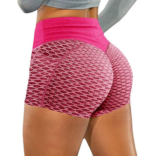 Stylish women's gym shorts with breathable fabric and vibrant pink color. Designed for comfortable workouts and yoga sessions.