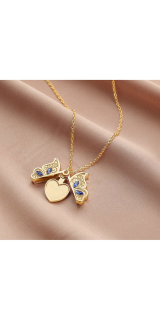 Delicate gold-toned butterfly pendant with heart shape and sparkling crystals, resting on a fine chain necklace, showcasing chic and feminine jewelry design.