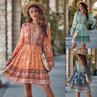 Elegant floral print mini dress with long sleeves, V-neck, and bell-shaped silhouette, complemented by a fashionable straw hat in an outdoor setting with trees.
