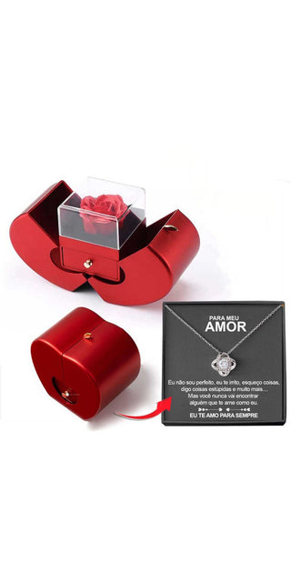 Red cube-shaped jewelry box with a rose in a glass dome, displaying an elegant, romantic gift.