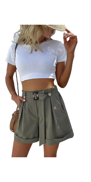 Stylish green shorts with a belt, paired with a white crop top, creating a casual yet chic ensemble on display in the image.
