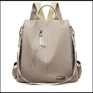Stylish beige backpack with silver zipper detailing, designed for modern women on the go at K-AROLE.