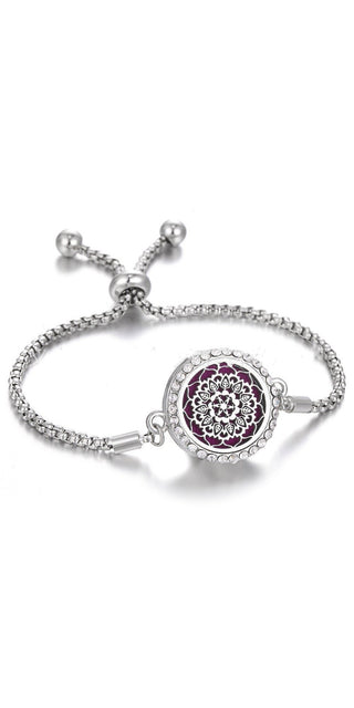 Elegant stainless steel adjustable bracelet with a floral-patterned, crystal-encrusted charm centerpiece, versatile jewelry piece.