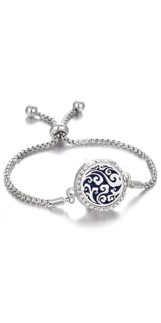 Adjustable stainless steel aromatherapy bracelet with intricate floral design and sparkling crystal accents, ideal for personal style and fragrance enjoyment.