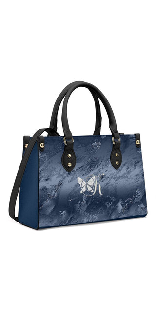 Stylish navy blue tote bag with marble print and gold-tone hardware from K-AROLE. This fashionable handbag features a spacious interior, dual top handles, and a detachable shoulder strap for versatile carrying options. The contemporary design elevates any women's athleisure outfit.