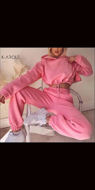 Stylish K-AROLE™️ women's pink 2-piece jogging suit with puff sleeves and belted waist, showcasing trendy activewear.