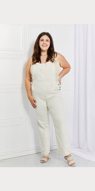 Stylish white overalls on a smiling woman, showcasing a trendy and comfortable fashion choice.