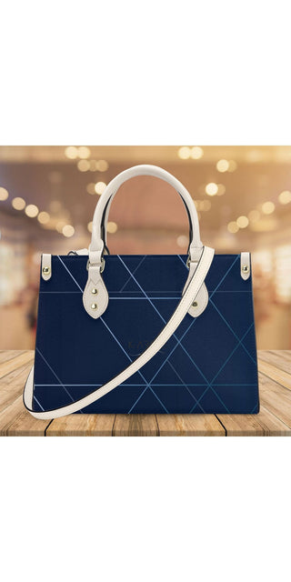 Stylish navy blue designer tote bag from K-AROLE. Featuring a sophisticated geometric pattern and sleek leather accents, this versatile accessory complements any casual or formal outfit.