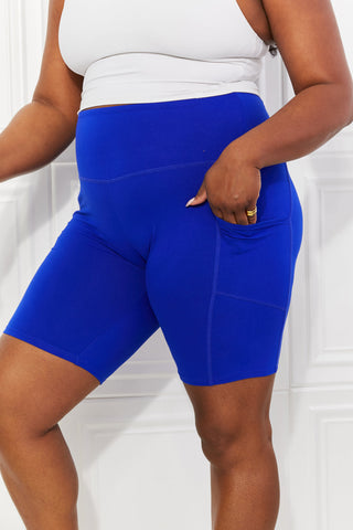 Chic athletic blue biker shorts with pockets, showcasing contemporary sportswear style.