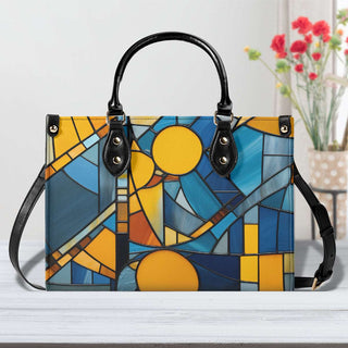 Chic stained-glass pattern tote bag with vibrant blue and yellow hues, sleek black handles, and elegant hardware accents. This fashionable handbag from the K-AROLE collection is a stylish accessory for everyday wear.