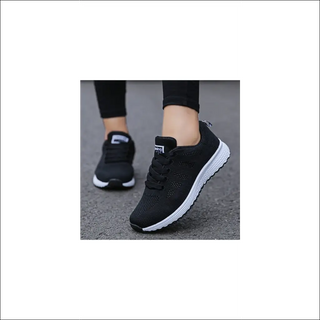 Sleek black mesh sneakers with lace-up closure for a sporty, comfortable women's casual footwear. The breathable design and flat sole make these ideal for everyday walking and gym workouts.