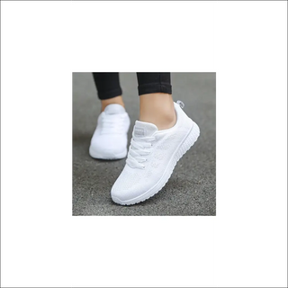 Stylish white women's casual sneakers with breathable mesh design, perfect for comfortable walking and gym workouts. Trendy and versatile footwear from the K-AROLE fashion brand.