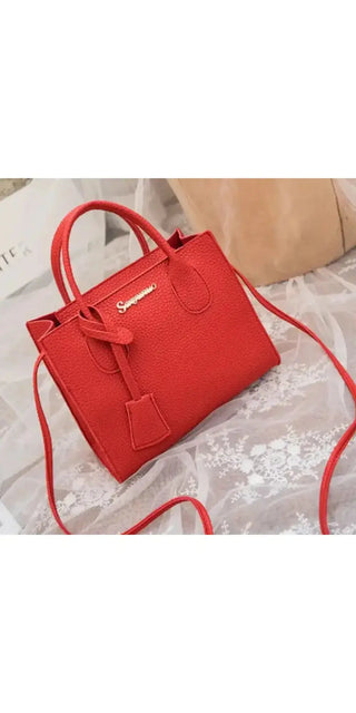 Stylish red leather handbag with a structured silhouette and a long, adjustable strap for versatile wear. The bag features a sleek, minimalist design and a tasseled zipper pull, making it an elegant and practical accessory.