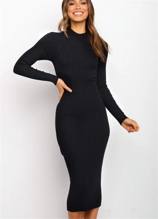 Sleek black knit dress with a bow backless detail, showcased on a smiling female model.