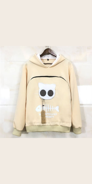 Cute feline-themed hoodie with large eye motif, stylish and cozy textile design for pet owners, featuring a soft beige color palette.