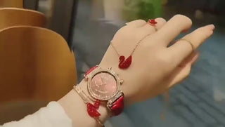 Elegant women's wristwatch with sparkling gemstones, displayed on a hand adorned with complementary jewelry accessories.