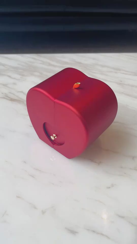 Stylish red cube candle holder on marble surface