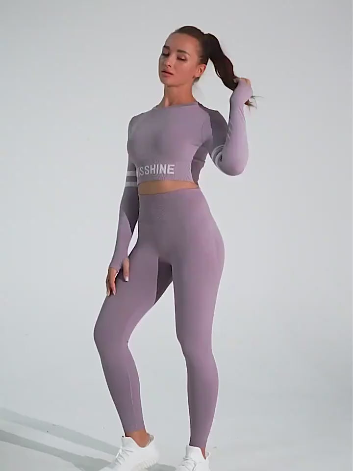 Stylish workout attire featuring lavender leggings and cropped top with "SHINE" graphic, showcasing a fashionable athletic look.