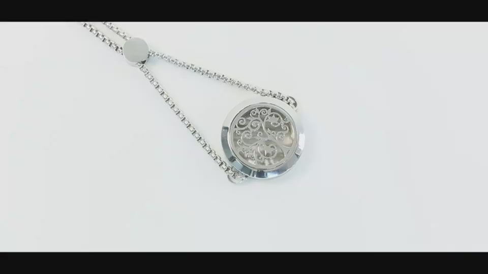 Elegant stainless steel locket necklace with floral design, adjustable aromatherapy jewelry for women.