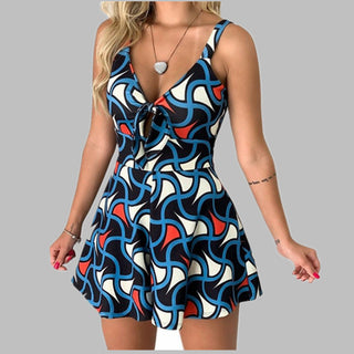 Stylish printed jumpsuit with bold geometric patterns in blue, white, and red. Features a low neckline and sleeveless design. Ideal for fashion-forward women seeking a trendy and eye-catching look.