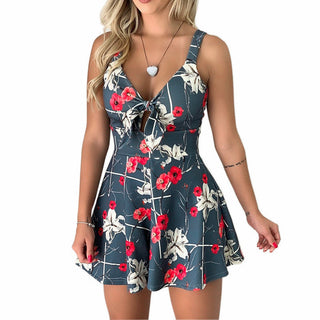 Floral print suspenders dress with plunging neckline, worn by a young woman with long blonde hair against a white background.