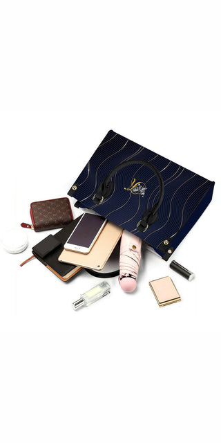 Luxury women's navy blue quilted leather tote bag with gold accents from K-AROLE, featuring chic cosmetic accessories.