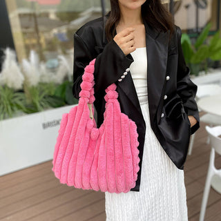 Stylish Pleated Wool Handbag: Vibrant pink pleated wool tote bag offset by a sophisticated black blazer for chic winter fashion.