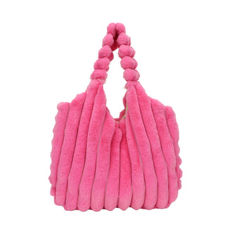 Plush pink handbag with a textured pattern and tassel details, showcasing a stylish and cozy winter accessory.
