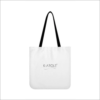 Stylish white tote bag with black handles and the K-AROLE logo prominently displayed, showcasing the versatile and trendy design of the brand's fashion accessories.