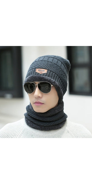 Stylish knitted winter hat and scarf set in dark grey, worn by a person in sunglasses, creating a modern, trendy look.