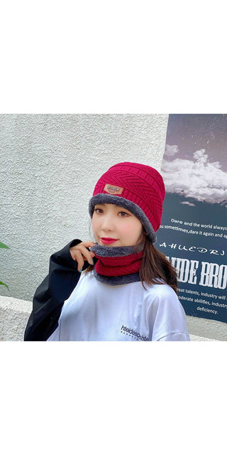Fashionable knitted hat and scarf set in vibrant red color, worn by a young woman against a snowy background, showcasing a cozy and stylish winter outfit.