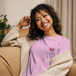 Relaxed and stylish women's t-shirt from K-AROLE brand, featuring a butterfly logo design on a pink background and paired with a cozy knit sweater.