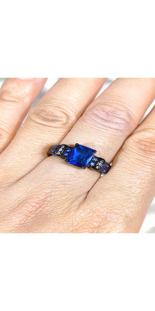 Sparkling blue gemstone rings - Captivating 1 CT blue cubic zirconia stones set in a stunning wedding band design on fingers. The elegant, eye-catching rings from the K-AROLE fashion jewelry collection exude sophistication and style.