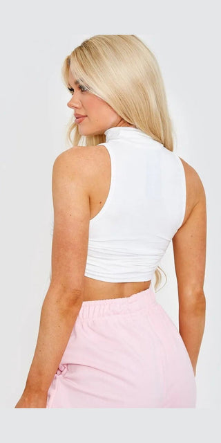 Sleek white cropped top with side tie detail, showcased on a female model with flowing blonde hair.