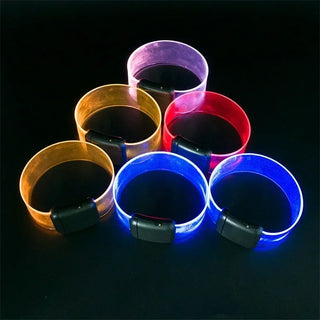 Colorful LED light-up bracelets for party events and safety. Vibrant silicone bands with sound-activated flashing lights in various vivid hues including blue, red, purple, and yellow. Trendy fashion accessory and luminous cheering props.